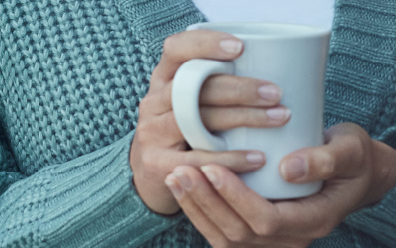 Test Mobile Woman leaning against patio door with tea mug